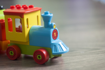 Budapest, Hungary - 07/30/2018: Toy Colorful blocks Train on the wooden floor with bokeh background. Shallow dof.