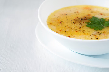bowls of vegetable soup puree with cheese and seasonings, copy space