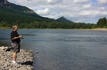 Fototapeta na wymiar Older man fishing Columbia River