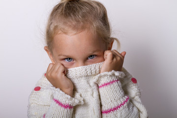 Beautiful natural young shy girl with smiling eyes wearing knitted sweater