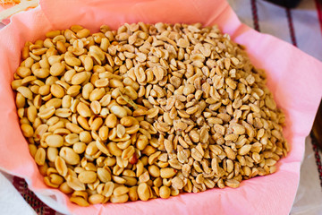 Close-up of a large amount of peeled salted peanuts in a basket