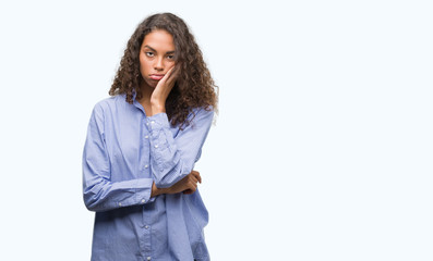 Young hispanic business woman thinking looking tired and bored with depression problems with crossed arms.