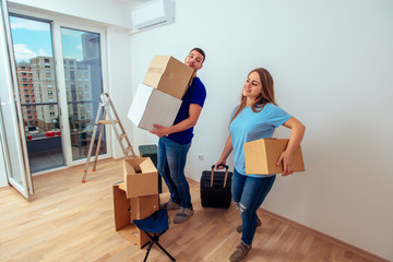 Fototapeta na wymiar Married couple wiwth luggage and boxes moving into a new apartment