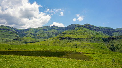 Fototapeta na wymiar Rich nature with grass and mountains, clouds, in Drakensberg Giant Castle, South Africa 