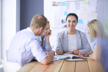 Obraz premium Young people studying with books on desk. Beautiful women and men working together