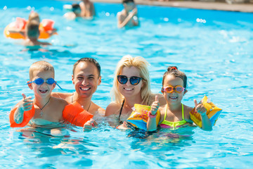 Happy family in swimming pool at water park
