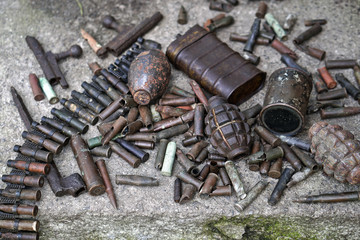 Military background with cartridges of grenades and machine-gun tape. Black archeology. World War II and its artifacts. Great Patriotic War of the USSR