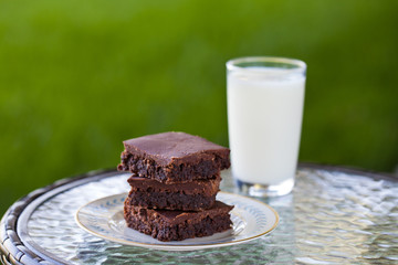 Homemade chocolate brownies with a glass of milk