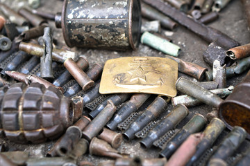 Military background with weapons trophies. The Second World War of Germany with the USSR and the countries of Europe. Coat of arms of the Soviet Union on a belt buckle.