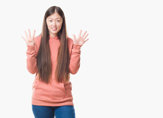 Young Chinese woman over isolated background wearing sport sweathshirt showing and pointing up with fingers number nine while smiling confident and happy.