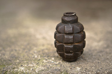 Neutralized grenade of the Second World War on a concrete background of a bunker. Dangerous...