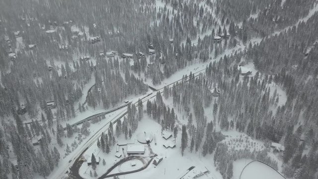 Pan right aerial, rural winter road in Lake Tahoe