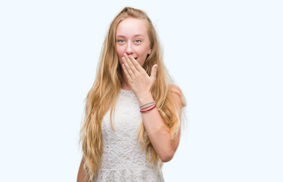 Blonde teenager woman cover mouth with hand shocked with shame for mistake, expression of fear, scared in silence, secret concept