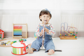 baby girl play trumpet at home