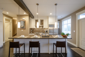 Fototapeta premium Modern, bright, clean, kitchen interior with stainless steel appliances in a luxury house.