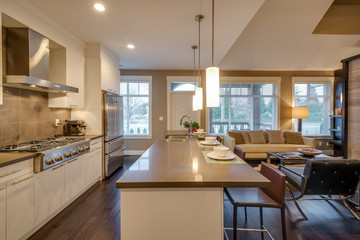 Modern, bright, kitchen and living room in a luxury house. Interior design.