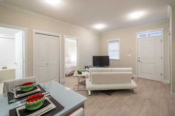 Bright living room with a dinner table and entertainment area. Interior design.