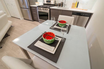 Modern bright kitchen with a dinner table. Interior design.