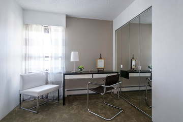 Modern bright home office interior with leather chair and desk.