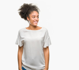 Young afro american woman over isolated background looking away to side with smile on face, natural expression. Laughing confident.