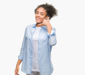 Young afro american woman over isolated background smiling doing phone gesture with hand and fingers like talking on the telephone. Communicating concepts.