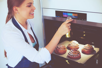Woman cook holding plate with homemade baked goods
