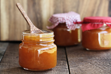 Homemade Salted Vanilla Cantaloupe Jam. Extreme shallow depth of field with selective focus on jar in front. Image could also be used for peach jelly or a marmalade.