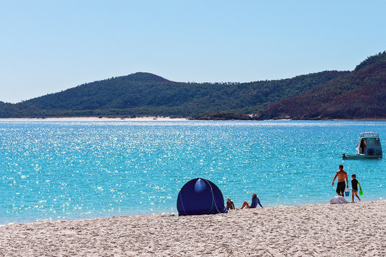 Tourists Relaxing Beside A Tent On A White Silica Sand Beach In Whitsundays Australia