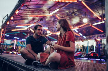 Fototapeta na wymiar Young happy couple/ Young happy couple enjoying themselves at the amusement park