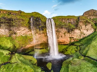  Iceland waterfall nature travel landscape in Icelandic nature background. Popular tourist attraction summer holiday destination in on South Iceland. Aerial drone view of top water falls. © Maridav