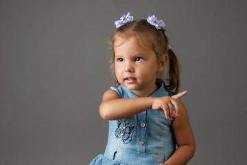 Cute little girl touching screen. Funny child girl pressing button on visual screen