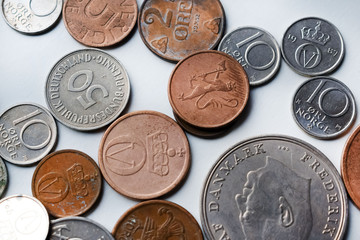 Modern and out of use coins of European countries. Selective or blurred focus with bright light.