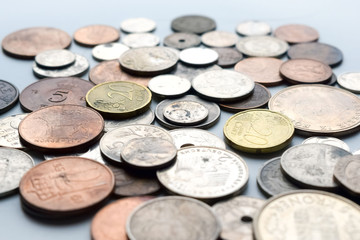 Modern and out of use coins of European countries. Selective or blurred focus with bright light.