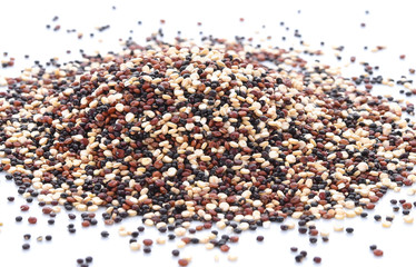 close up of uncooked quinoa, isolated on the white background, top view