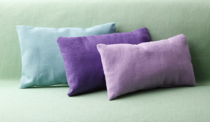 Pastel  green and violet pillows on the sofa