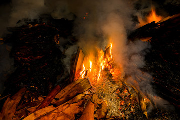 burning recyclable materials in the fire at night