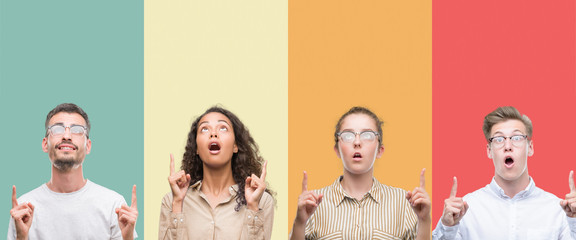 Collage of a group of people isolated over colorful background amazed and surprised looking up and...