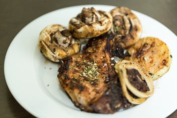 Grilled Steak, Mushrooms and Onion on the Plate - Close Up