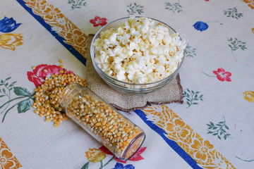 glass bowl with popcorn and corn seeds