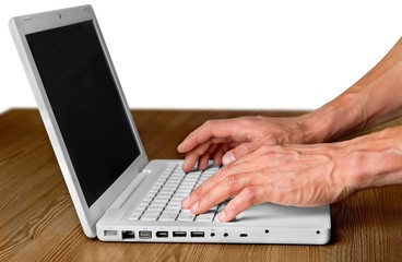 Hands Typing on a Laptop