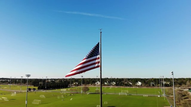 American flag hangs over field, aerial