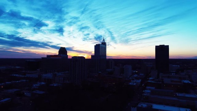 Wide aerial, scenic sunset over Raleigh skyline