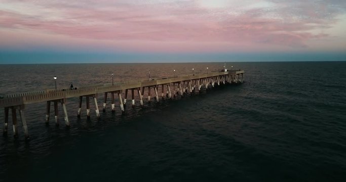 Sunset over pier in Wilmington, aerial