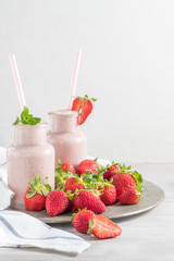 Strawberry milkshake or smoothie in glass jars