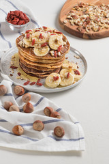Pancakes with banana, walnuts, goji and honey