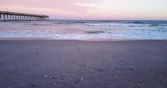 Waves crash on beach in Wilmington, sunset