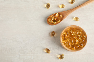 Flat lay composition with cod liver oil pills and space for text on light background © New Africa