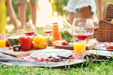 Blanket with food prepared for summer picnic outdoors, closeup