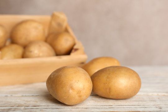Fresh ripe organic potatoes on wooden table