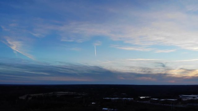 Wide, plane trail in sunset sky